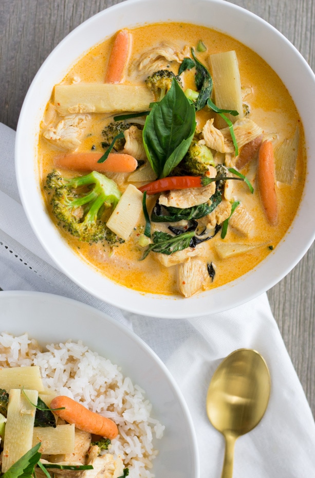 Large white bowl filled with curry and a smaller bowl with rice and a little curry inside.