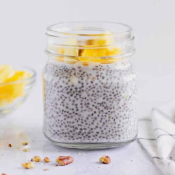Feature image of chia pudding in a mason jar with mango on top.