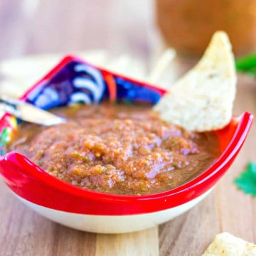 Up close shot of salsa in a bowl with a tortilla chip.