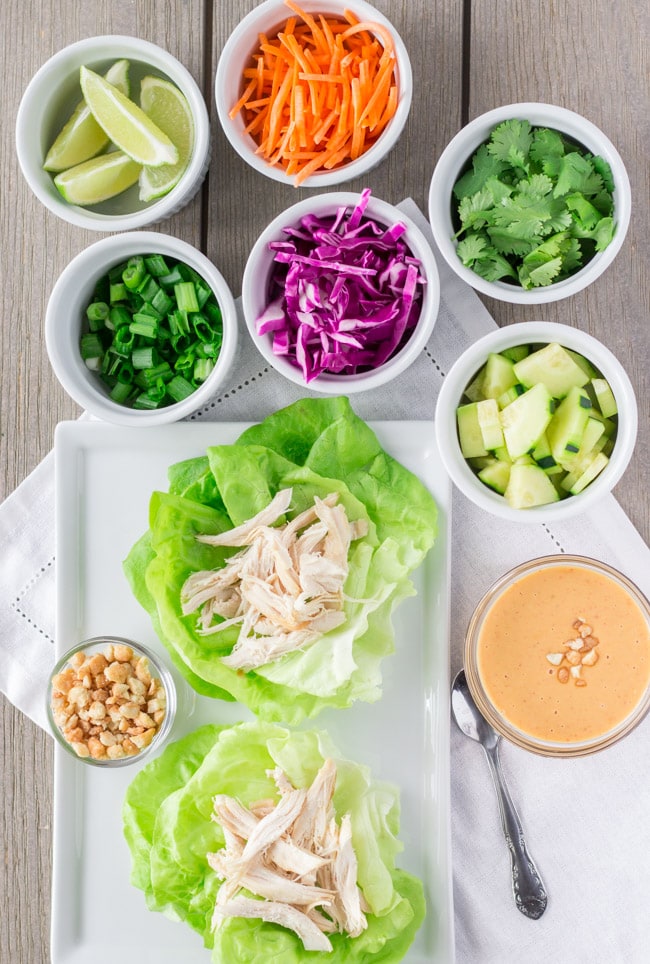 Overhead view of lettuce wraps with topping in individual cups.