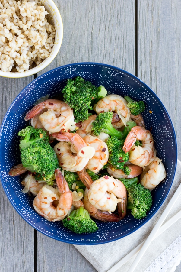 Shrimp and Broccoli in a blue bowl with a side of rice.