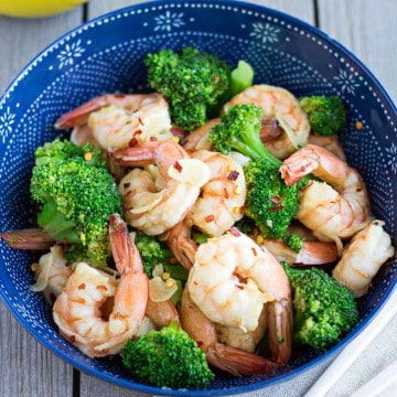 Feature image of shrimp and broccoli in a blue bowl.
