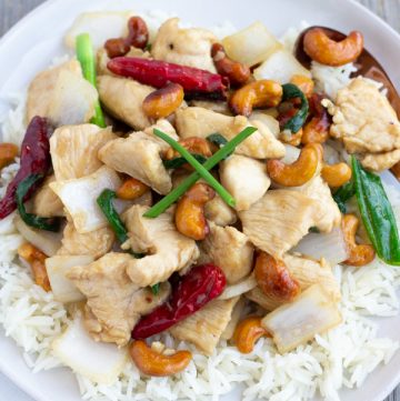 Thai Cashew Chicken Stir fry with roasted chili peppers, onions, juicy chicken, and crunchy cashews- ThaiCaliente.com