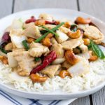 Thai Cashew Chicken Stir fry with roasted chili peppers, onions, juicy chicken, and crunchy cashews- ThaiCaliente.com
