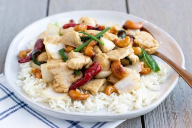 Thai Cashew Chicken Stir fry with roasted chili peppers, onions, juicy chicken, and crunchy cashews- ThaiCaliente.com