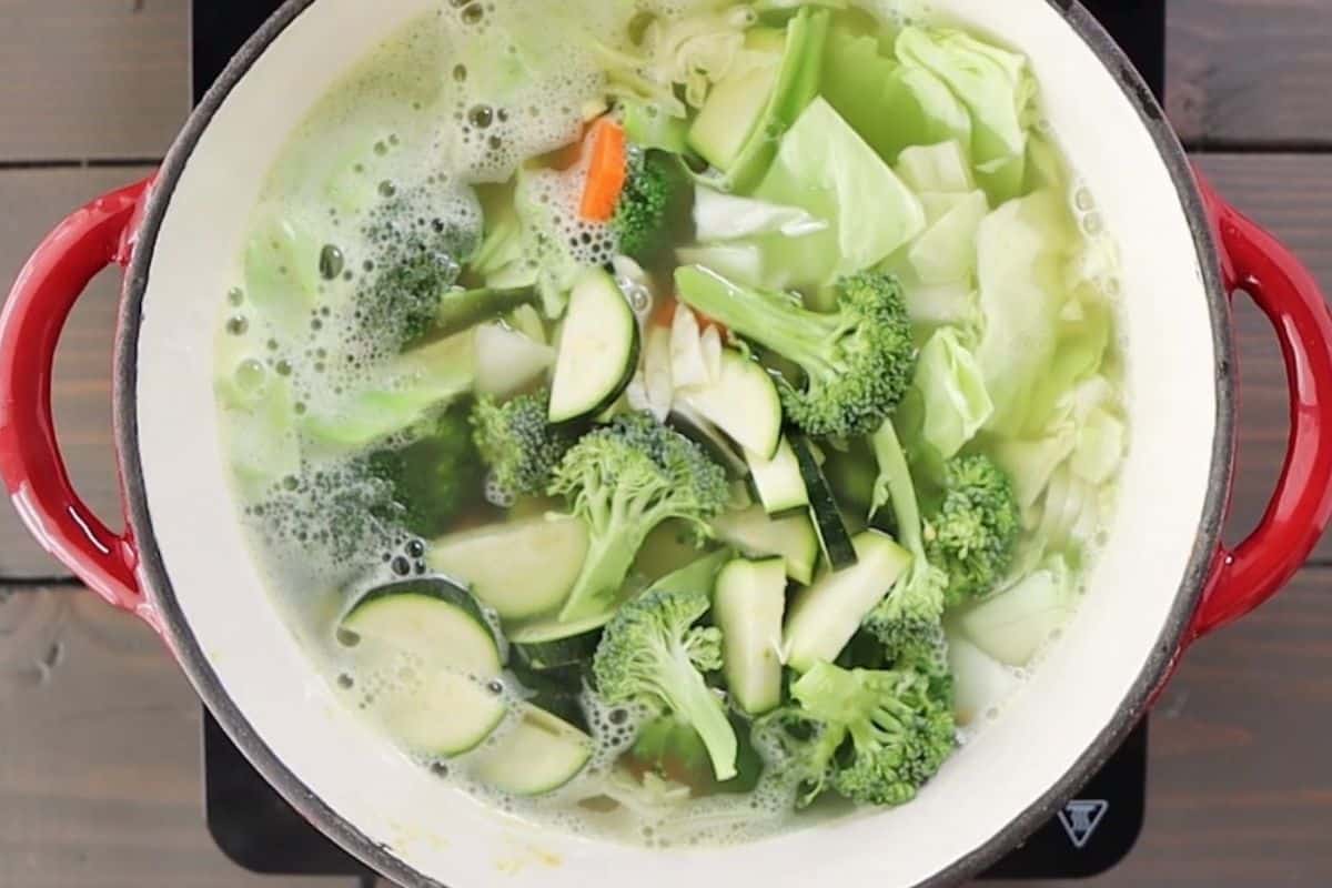 Cooking vegetables in a broth.