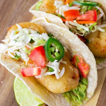 Fried Shrimp tacos on corn tortillas topped with cabbage slaw.