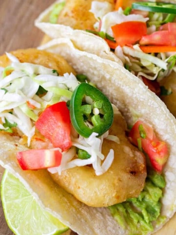 Fried Shrimp tacos on corn tortillas topped with cabbage slaw.