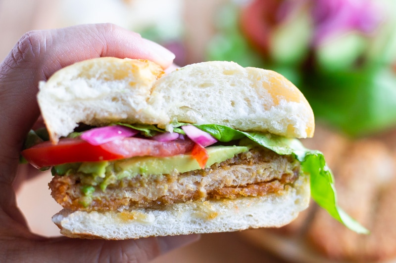 Hand hold Torta that has been cut in half.