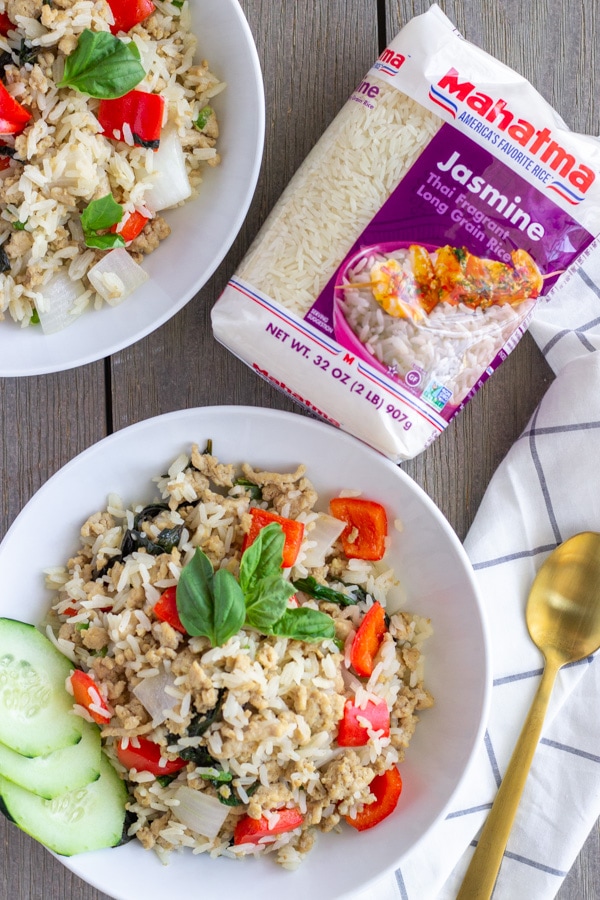 Two white bowls with finished Thai Basil Fried rice and image of Mahatma Rice package.