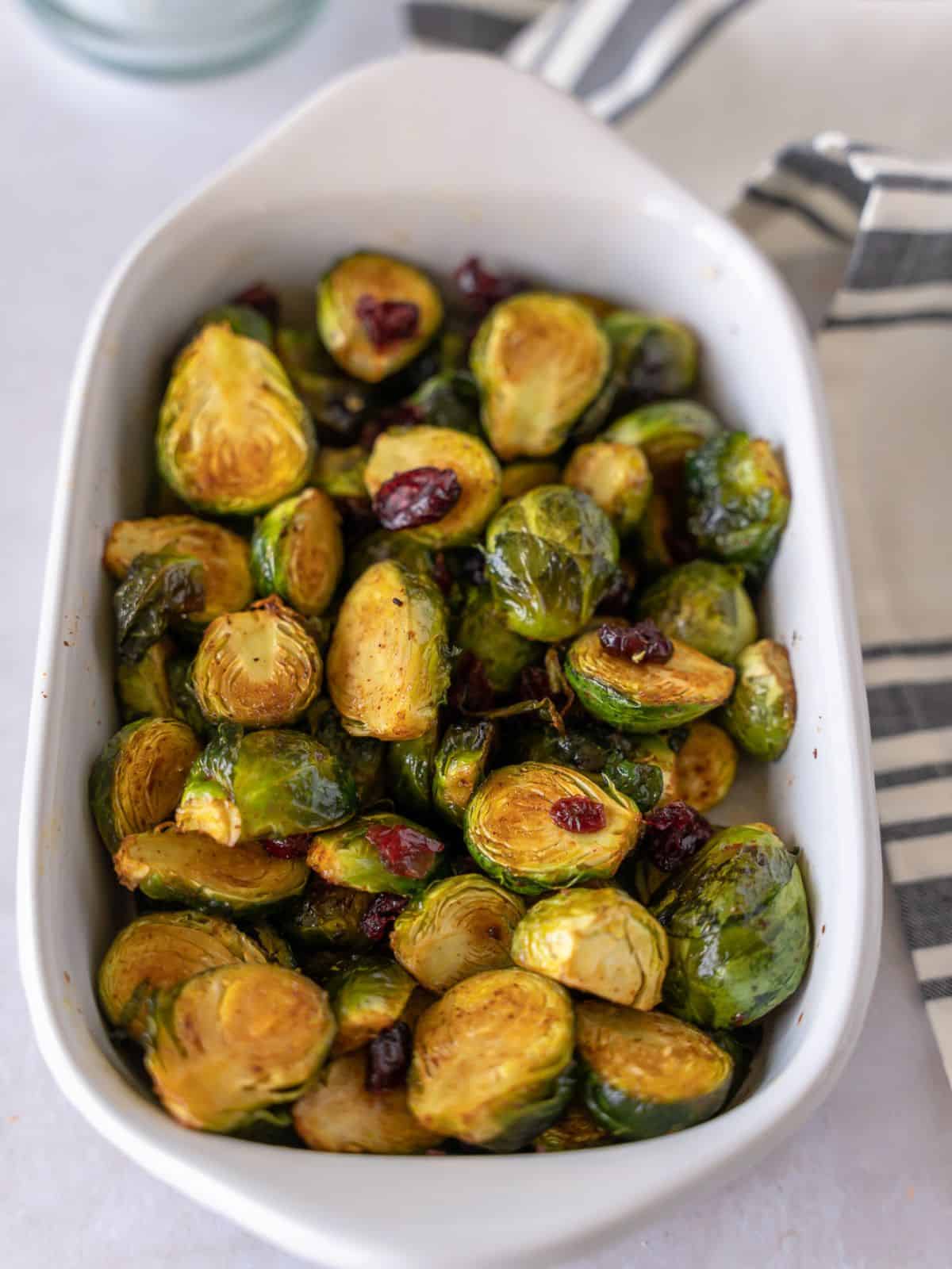 Roasted brussels sprouts in a white dish.