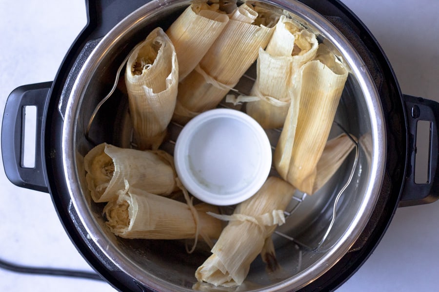 Tamales inside an instant pot ready to be cooked.