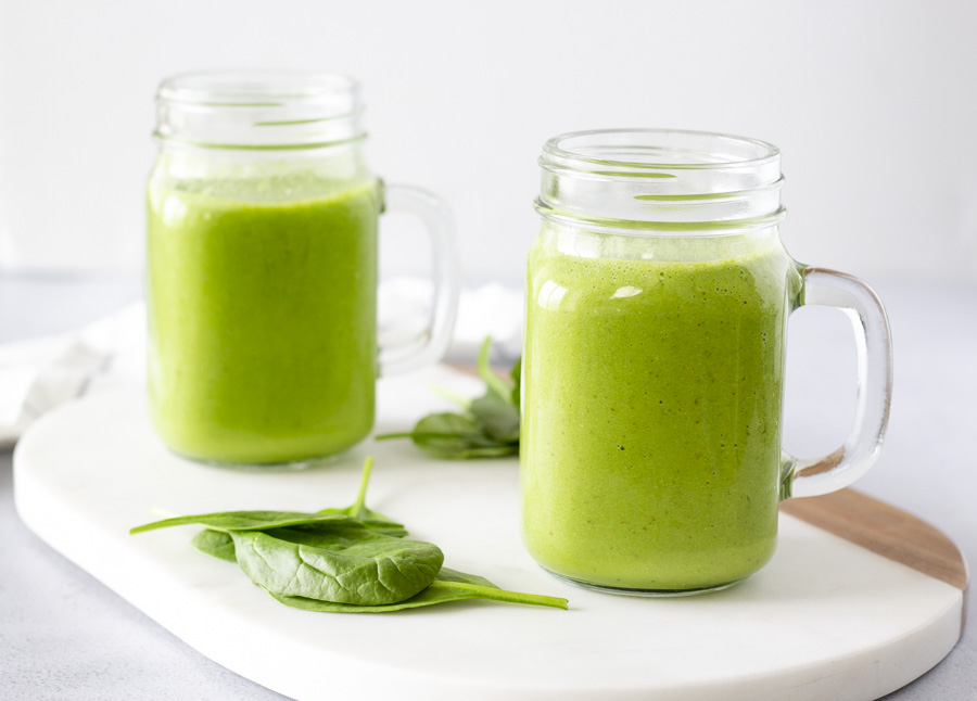 Landscape view of 2 green smoothies.