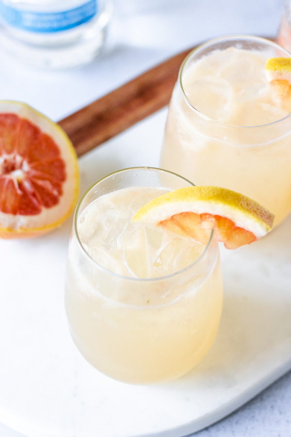 Overhead view of paloma in a glass on a marble cutting board.