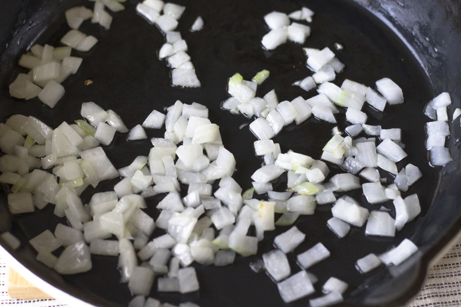 Onions cooking in a cast iron skillet