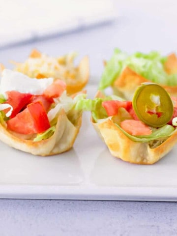 Feature image of taco wonton cups on a plate.