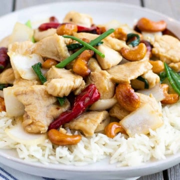 Feature image of cashew chicken on a plate with rice.