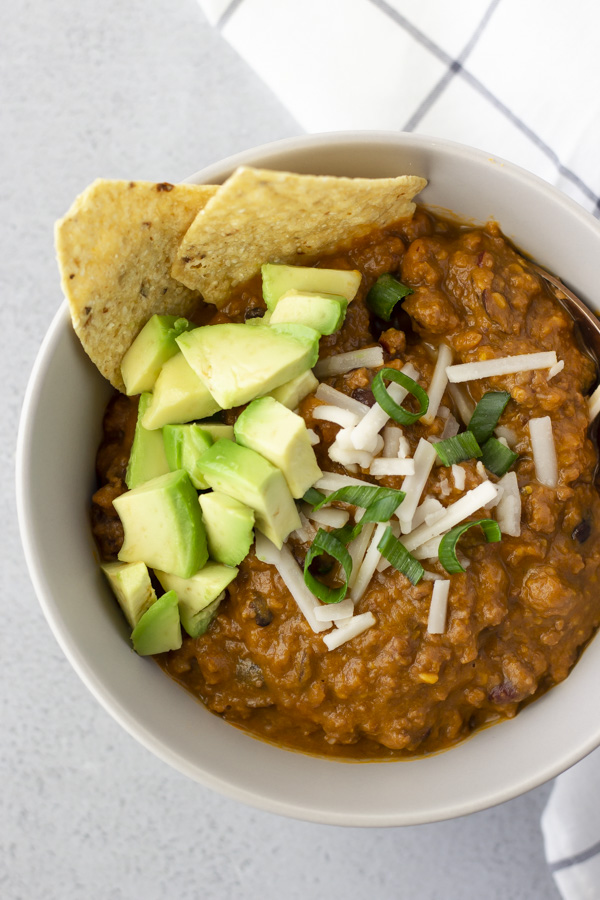 Overhead view of chili in a beige bowl.