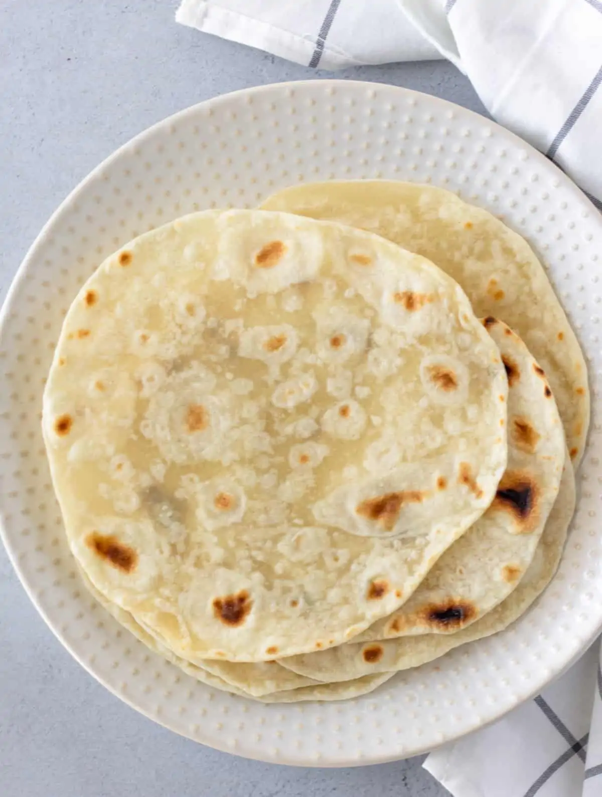 Overhead view of tortillas on a plate.