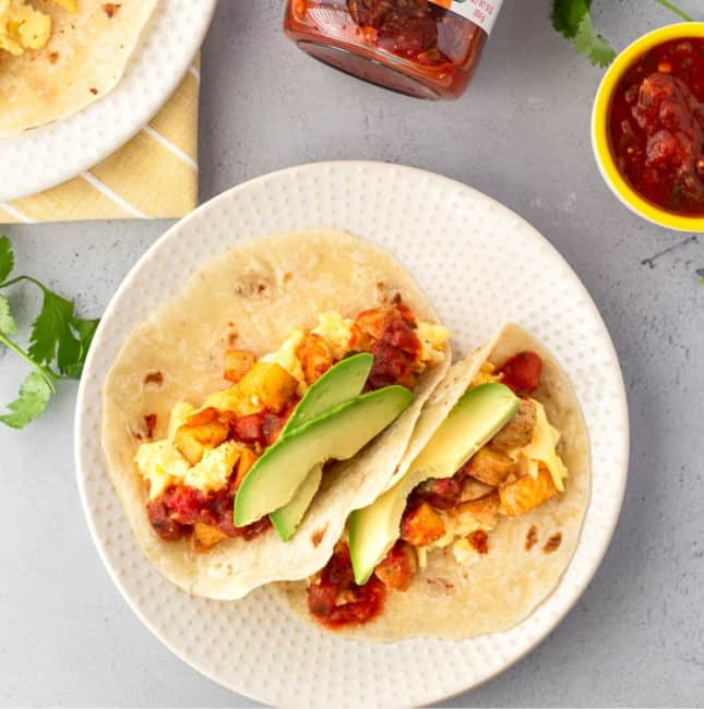 Square feature image of 2 tacos on a plate with a small bowl of salsa on the side.