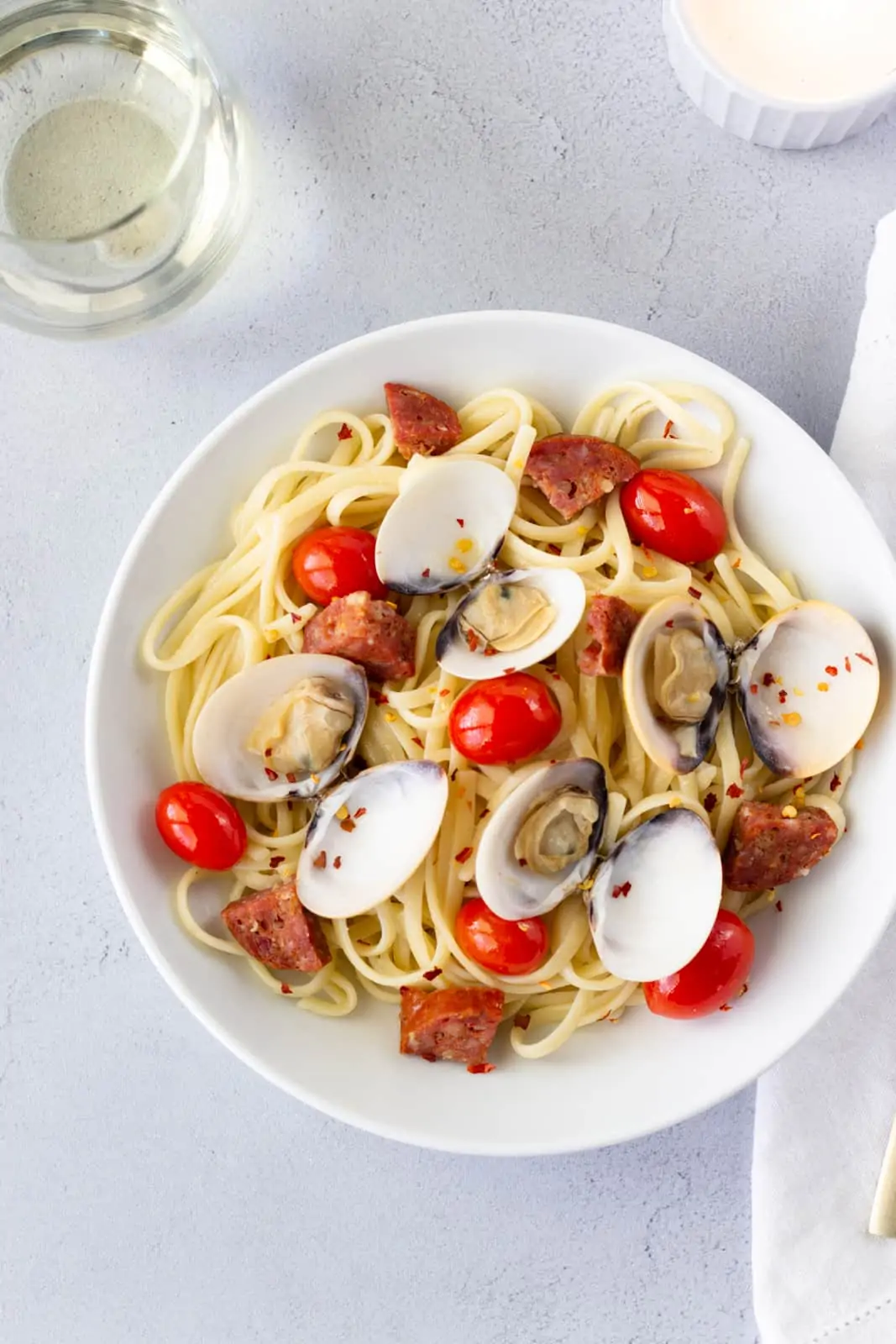 Overhead view of dish with a glass of white wine on the side.
