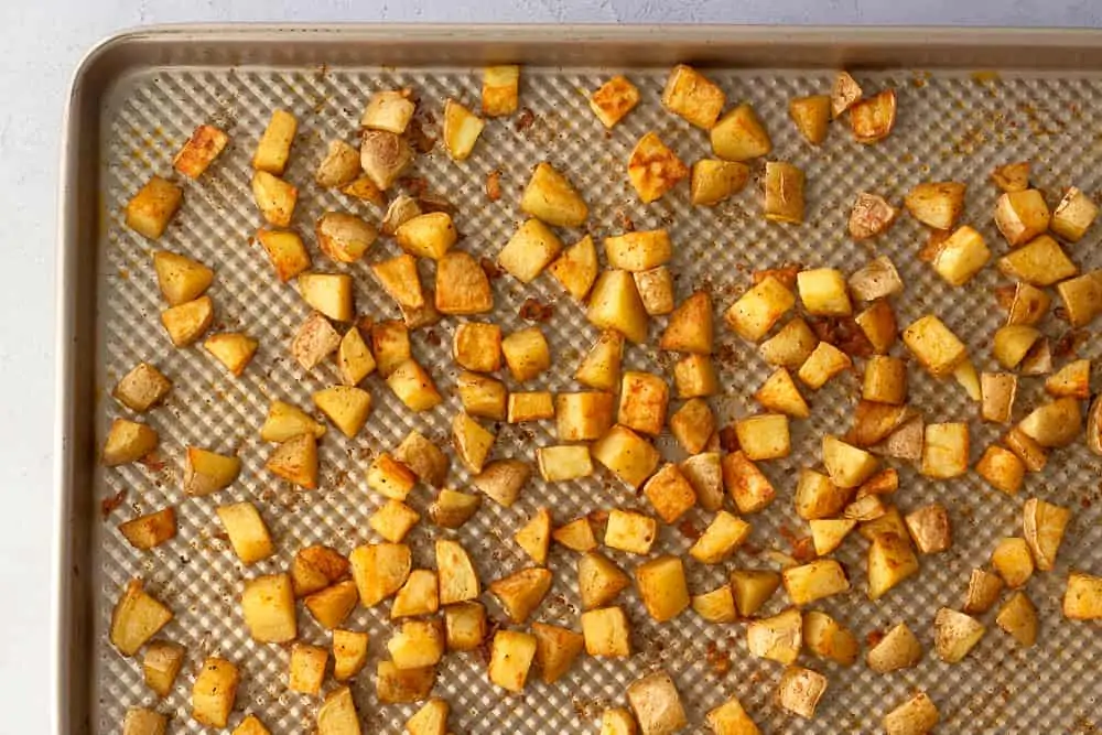 Sheet pan of baked crispy potatoes.
