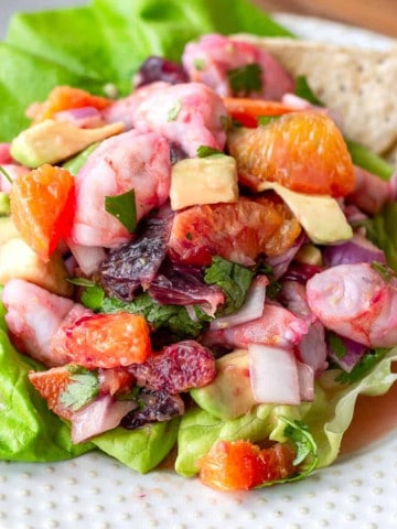 Citrus Shrimp Ceviche on a plate with a bed of lettuce.