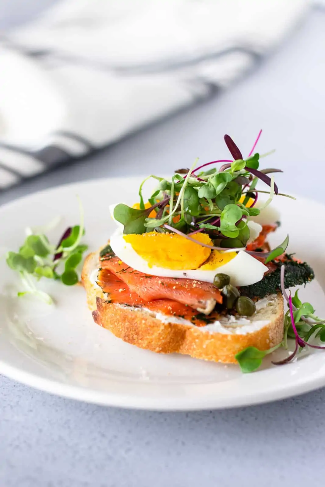 Salmon lox toast with hard boiled egg and micro greens on top