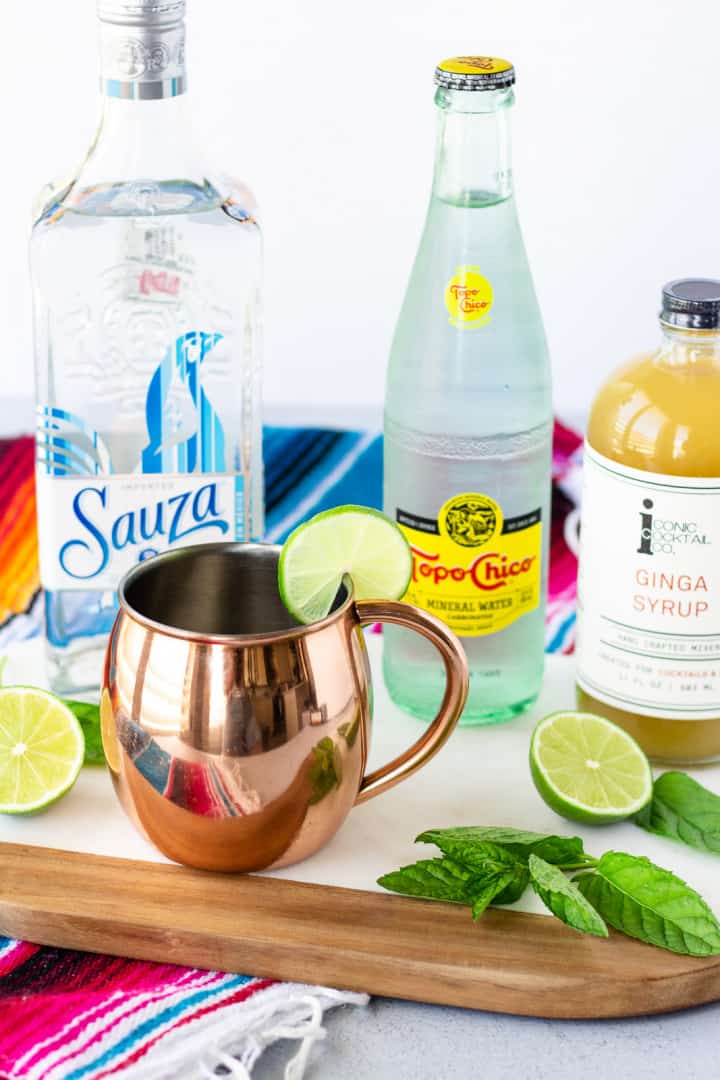 Ingredients for cocktail- Tequila, Topo Chico, Ginga Syrup, lime, and mint leaves.