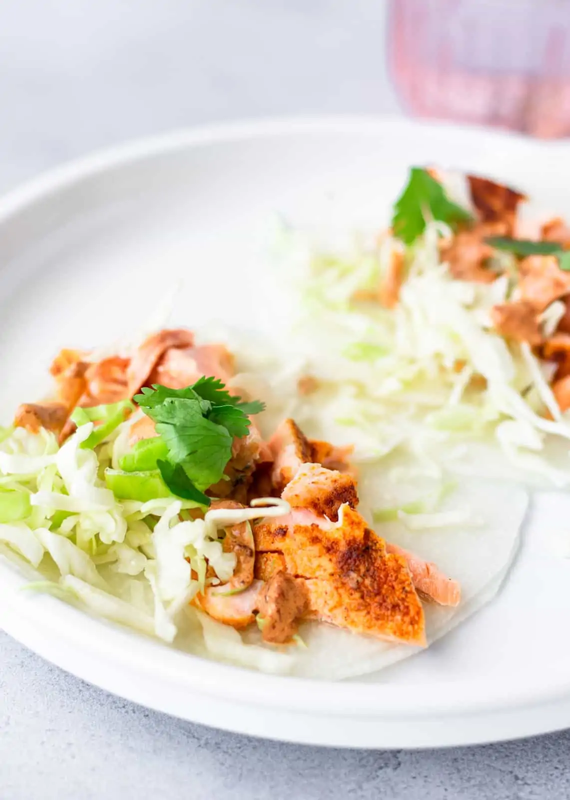 Flaked salmon on jicama wraps with shredded lettuce and cilantro.