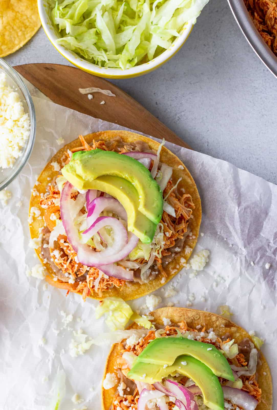 Overhead view of assembled tostadas on parchment paper