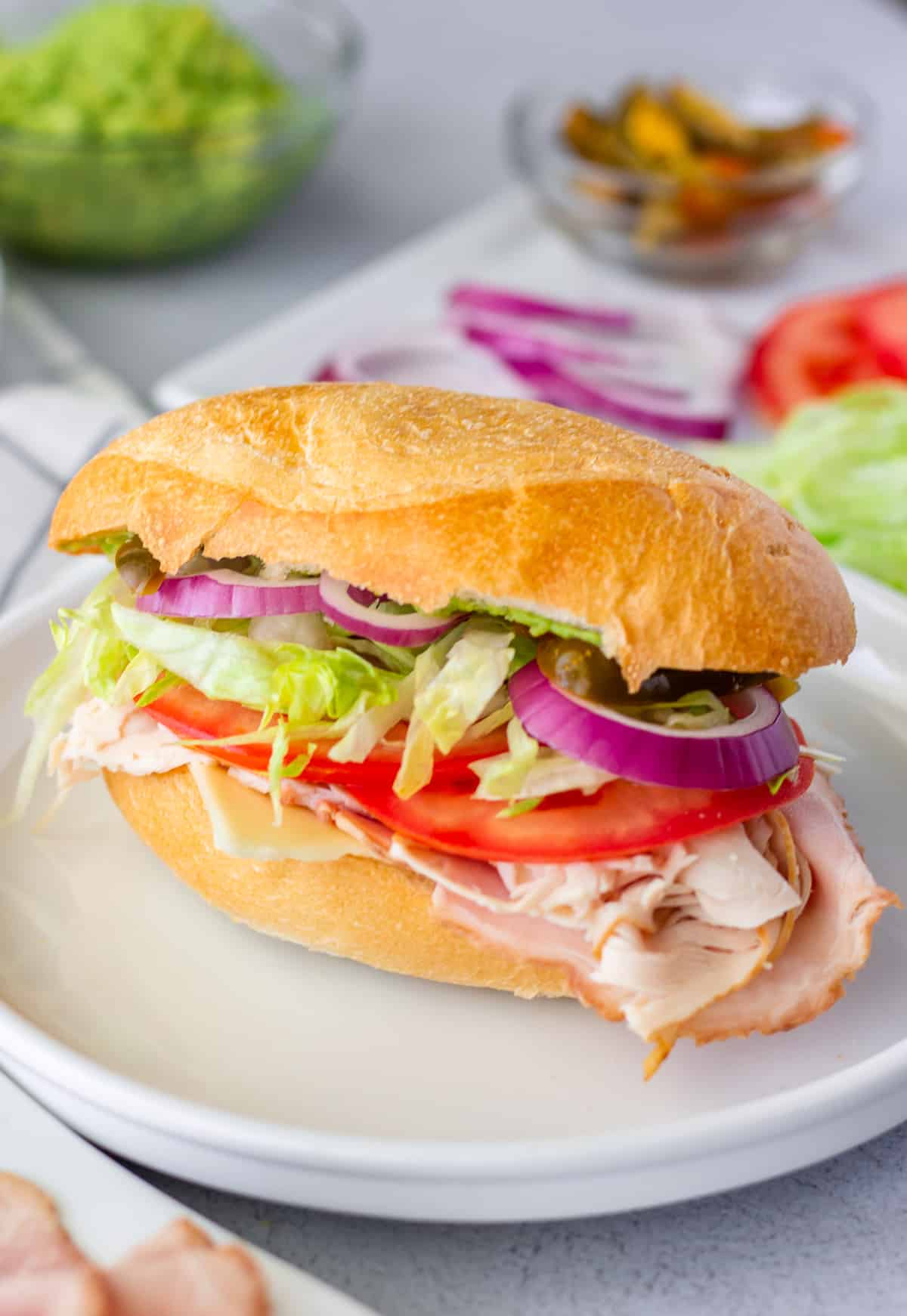 Assembled lonche de jamon on a white plate.