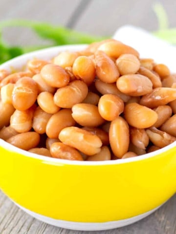 Whole Peruvian Beans in a small yellow bowl.