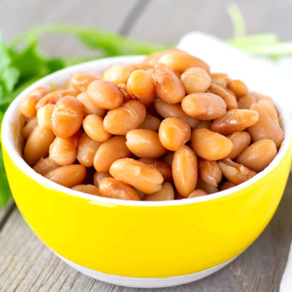 Whole Peruvian Beans in a small yellow bowl.