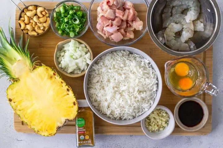 Overhead view of ingredients on a wood cutting board.