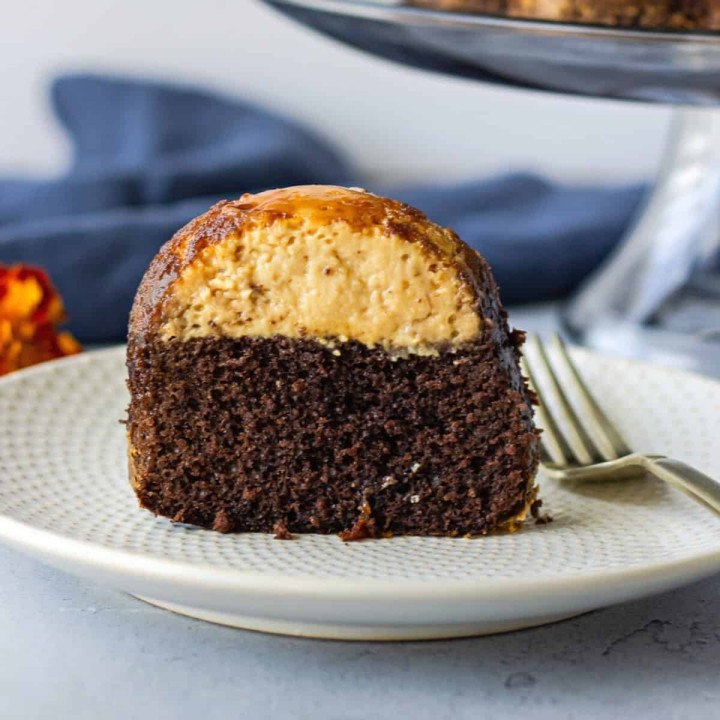 Up close view of a slice of chocoflan on a plate.