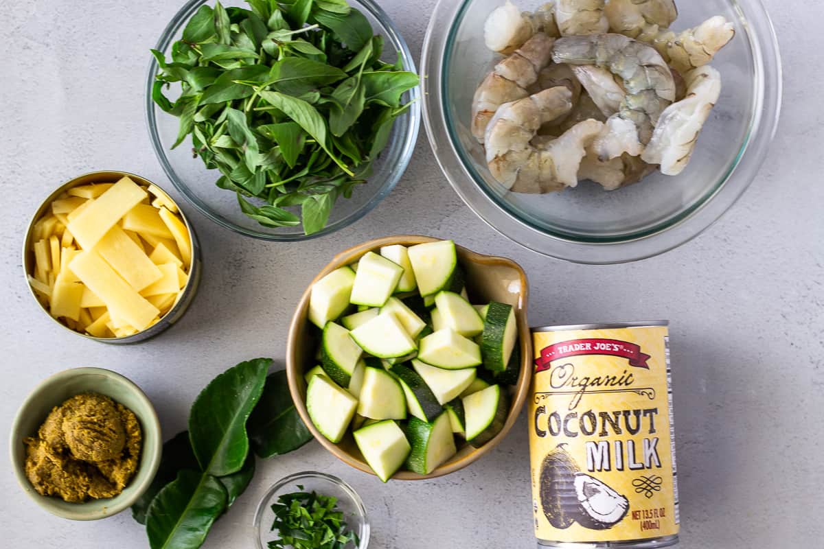 Shrimp, Basil, zucchini, bamboo, curry paste, and coconut milk in separate bowls.