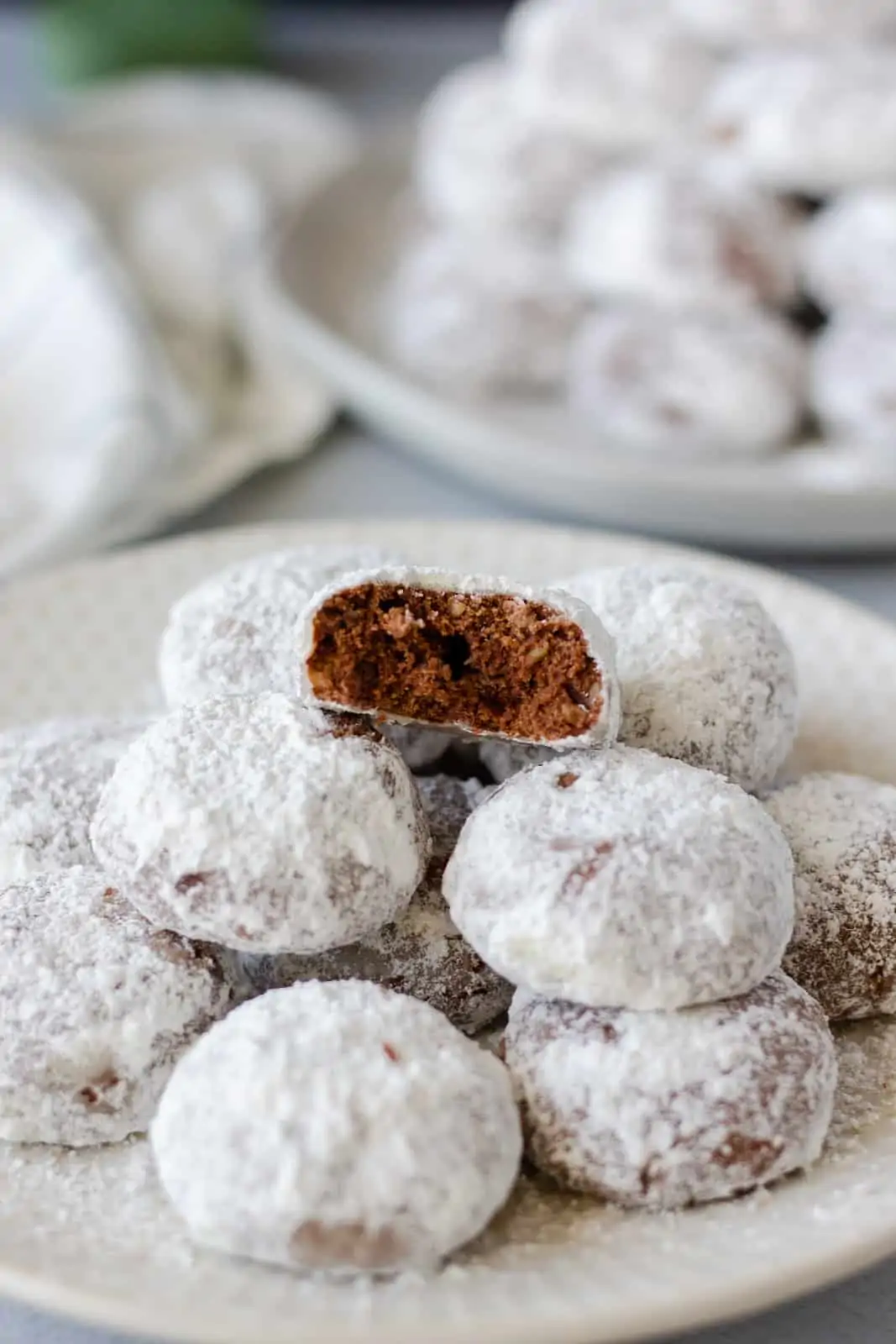 Cookies on a plate with one that has a bite taken out.