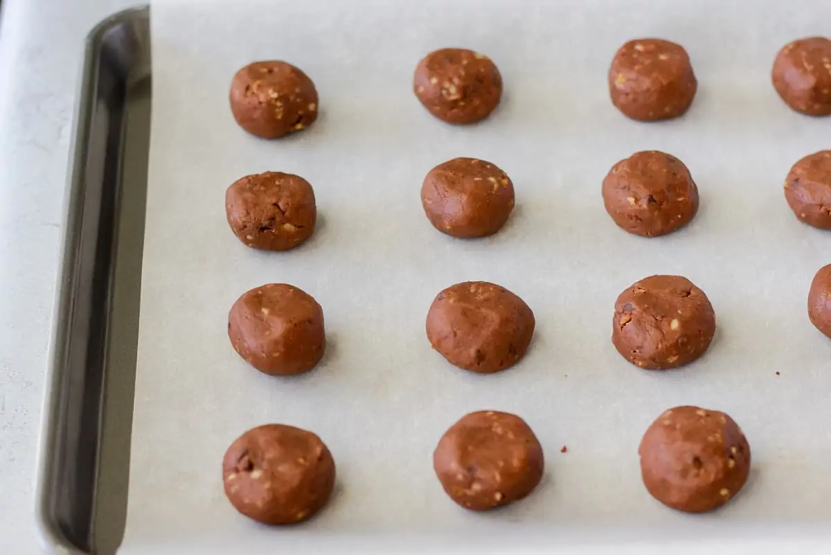 Rolled cookie dough on a baking sheet with parchment paper.