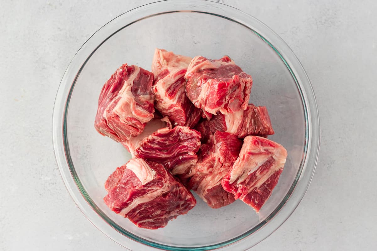 Diced Chuck roast in a glass bowl.