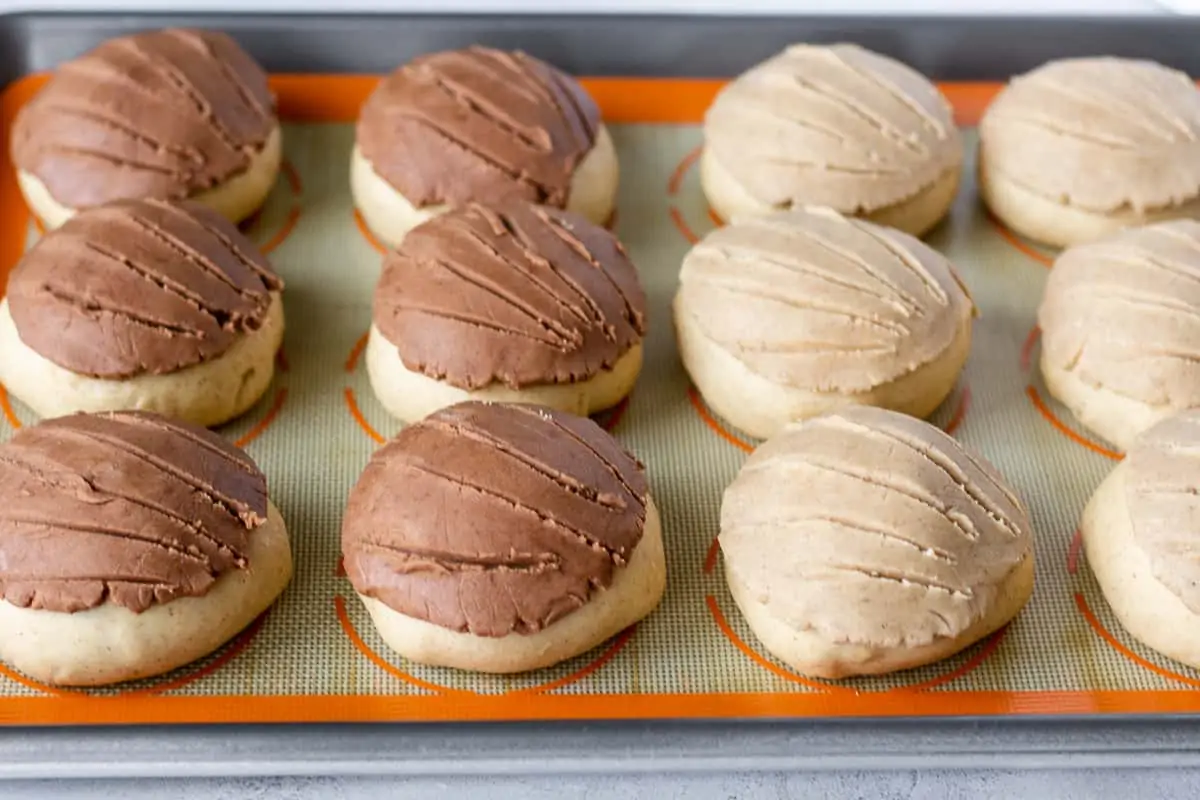 Sugar topping on unbaked concha dough with shell pattern.