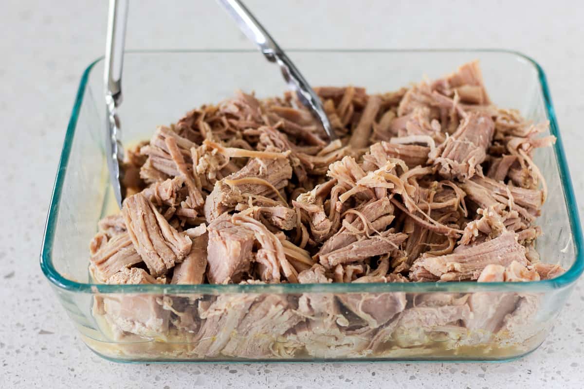Shredded pork in a glass container.