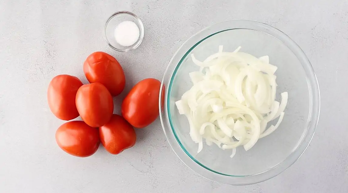 Whole roma tomatoes, sliced onions, and salt.