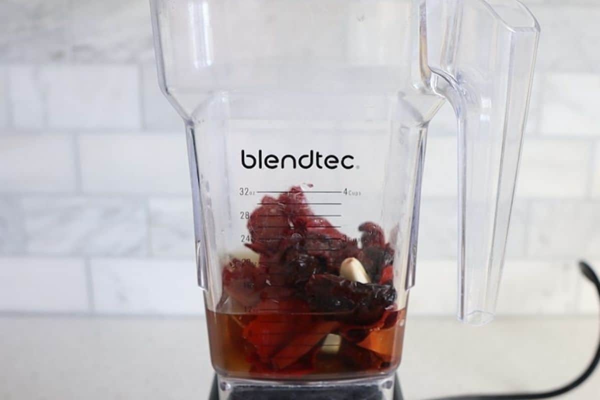 Rehydrated chiles with water in a blender.