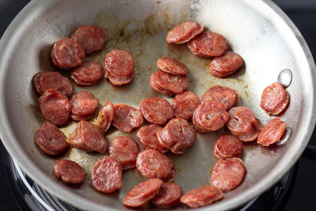 Cooked Chinese Sausage in skillet.