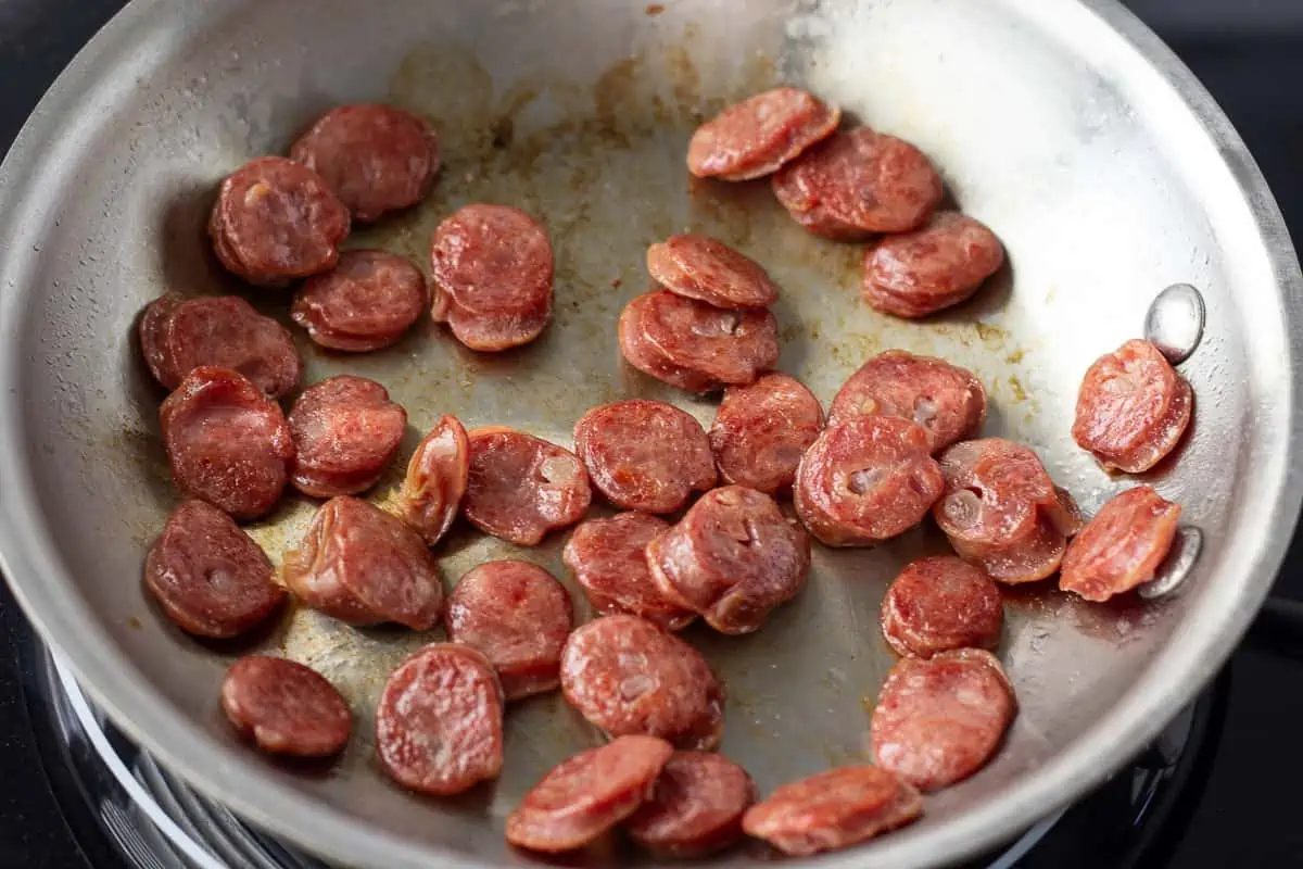Cooked Chinese Sausage in skillet.