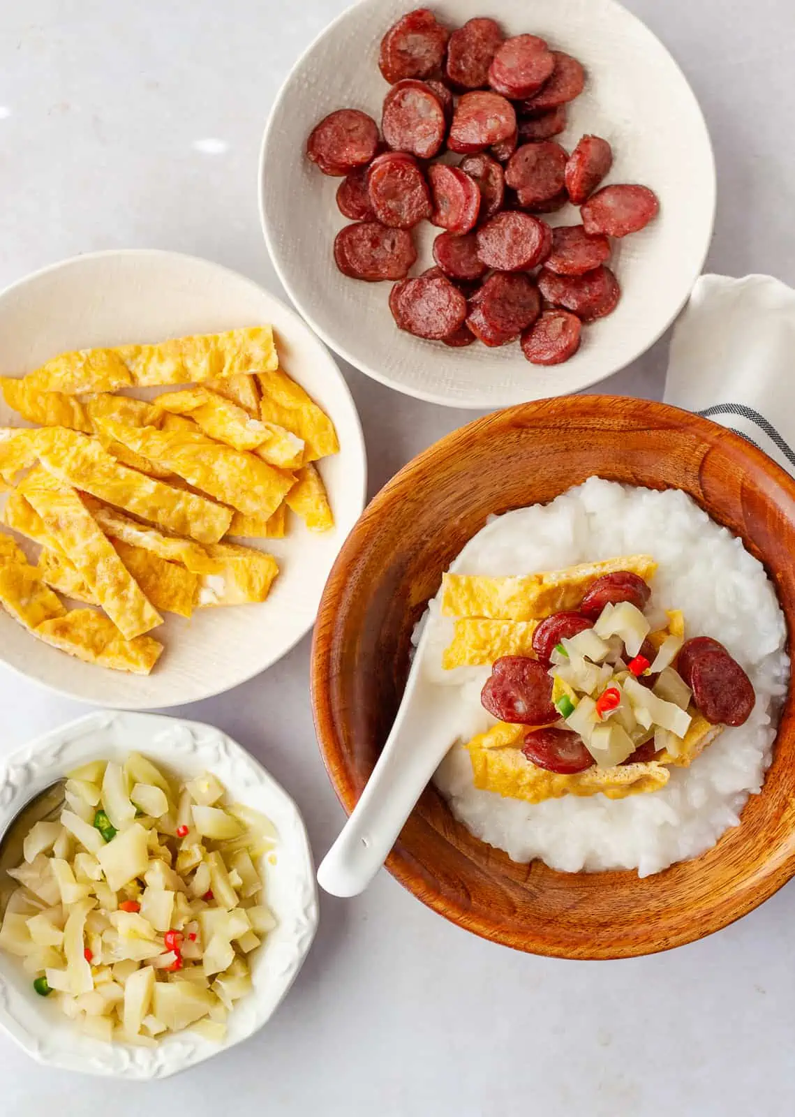 Toppings in individual bowls and completed kha tom.