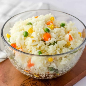 Feature image of arroz primavera in a glass bowl.