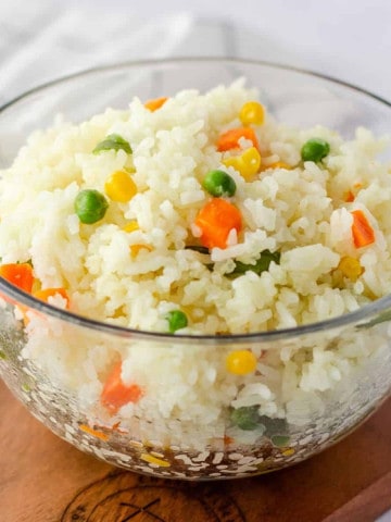 Feature image of arroz primavera in a glass bowl.