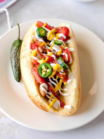 Feature image of Sonoran hot dog with toppings.